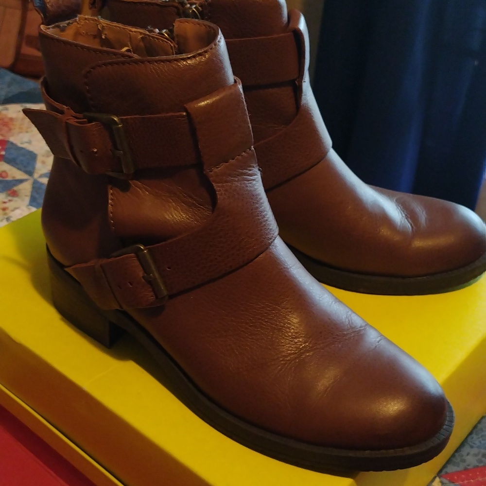 These are a pair of Kenneth Cole Reaction ankle boots with side zippers